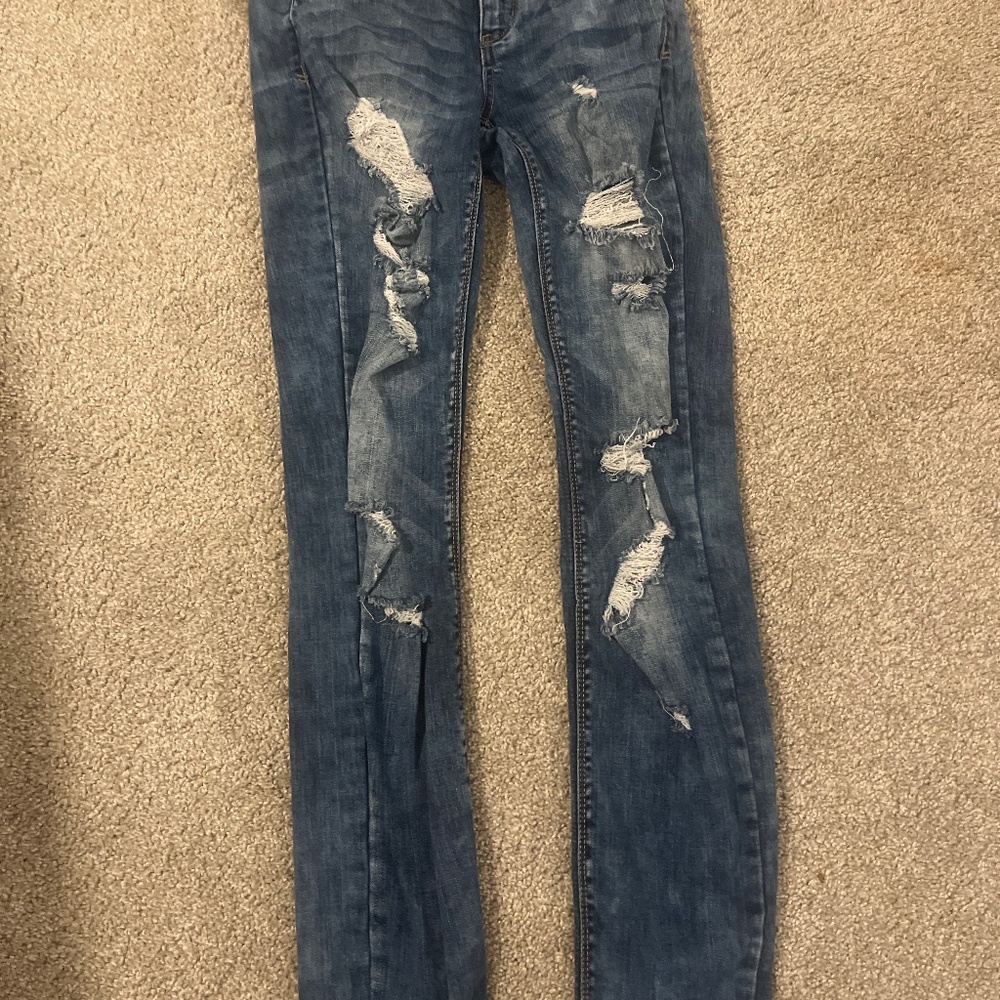 Dark blue low rise ripped skinny jeans